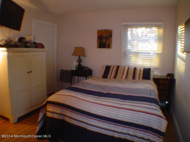 240 Crows Nest Road Manahawkin, NJ 08050 - Photo 15 of 26 a bedroom with a bed and flat screen tv