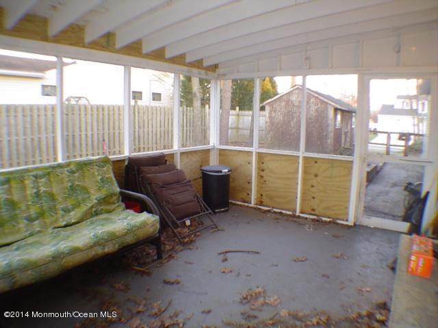 240 Crows Nest Road Manahawkin, NJ 08050 - Photo 22 of 26 a living room with furniture and a gate