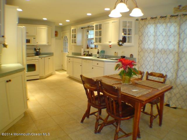 240 Crows Nest Road Manahawkin, NJ 08050 - Photo 3 of 26 a kitchen with a table and chairs in it