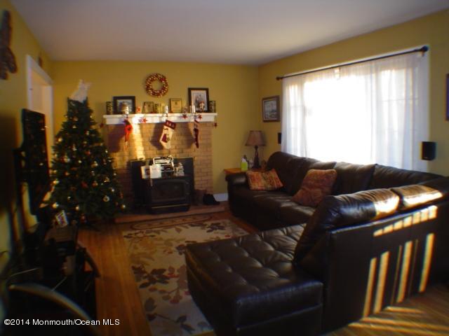 240 Crows Nest Road Manahawkin, NJ 08050 - Photo 7 of 26 a living room with furniture and a fireplace