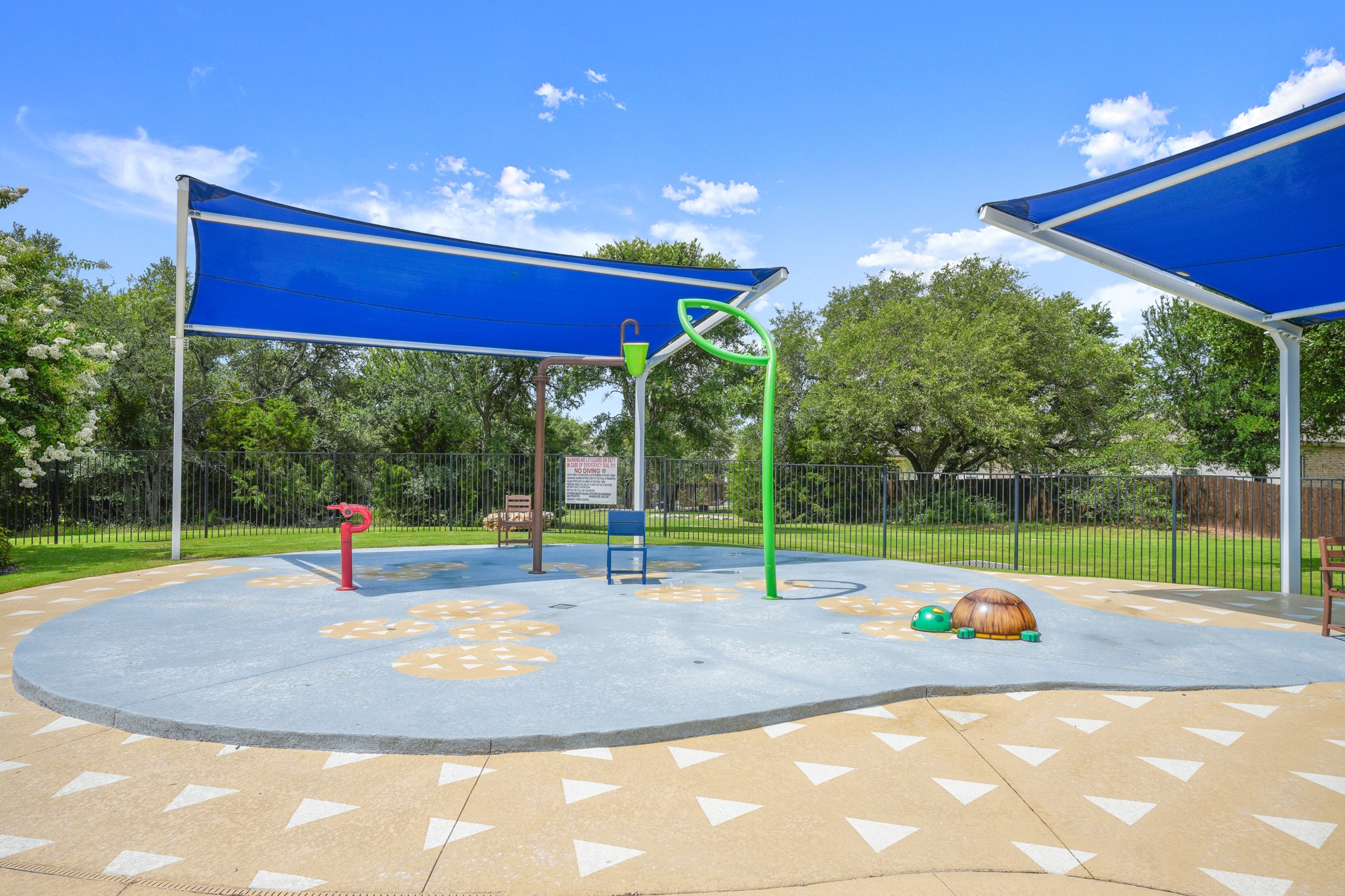 152 Mountain Valley Street Georgetown, TX 78628 - Photo 27 of 38 Shaded splash pad recreation area surrounded by a secure fence and mature trees.