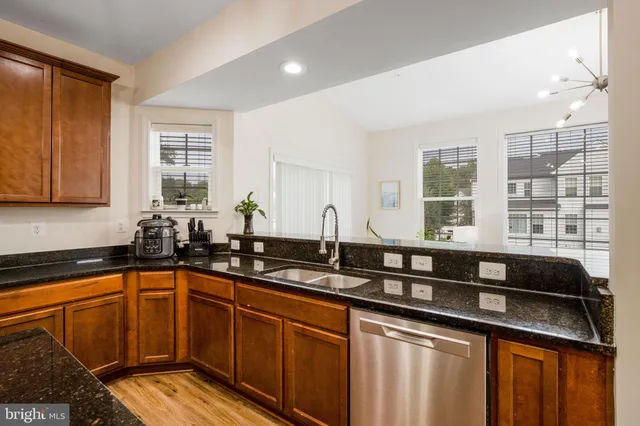 a kitchen with granite countertop a sink and cabinets