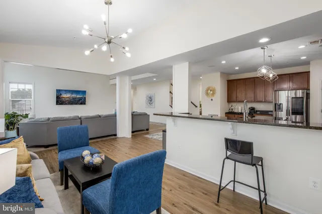 a living room kitchen with furniture and kitchen view