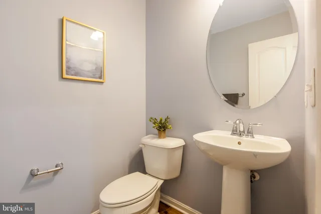 a bathroom with a sink mirror and toilet