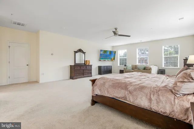 a spacious bedroom with a bed and window