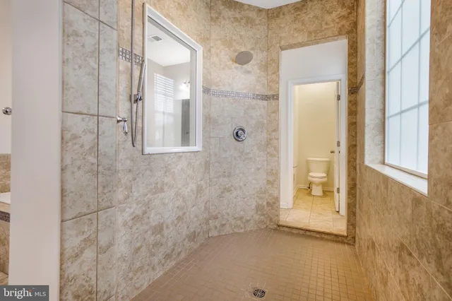 a bathroom with a glass shower door