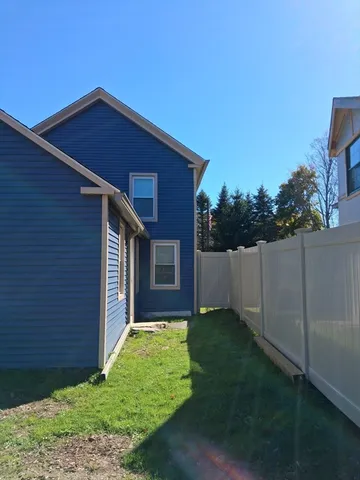 a view of house with backyard