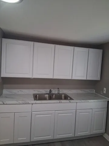 a kitchen with white cabinets