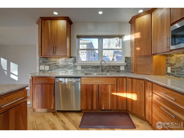 a kitchen with stainless steel appliances granite countertop a stove and a sink