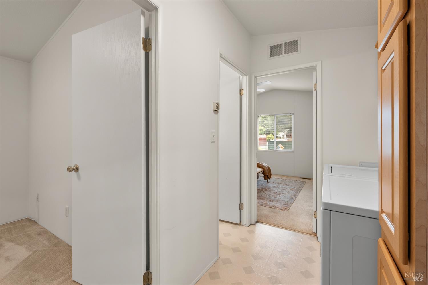 5754 Lois Avenue Santa Rosa, CA 95403 - Photo 14 of 23 a view of a hallway with bathroom and wooden floor