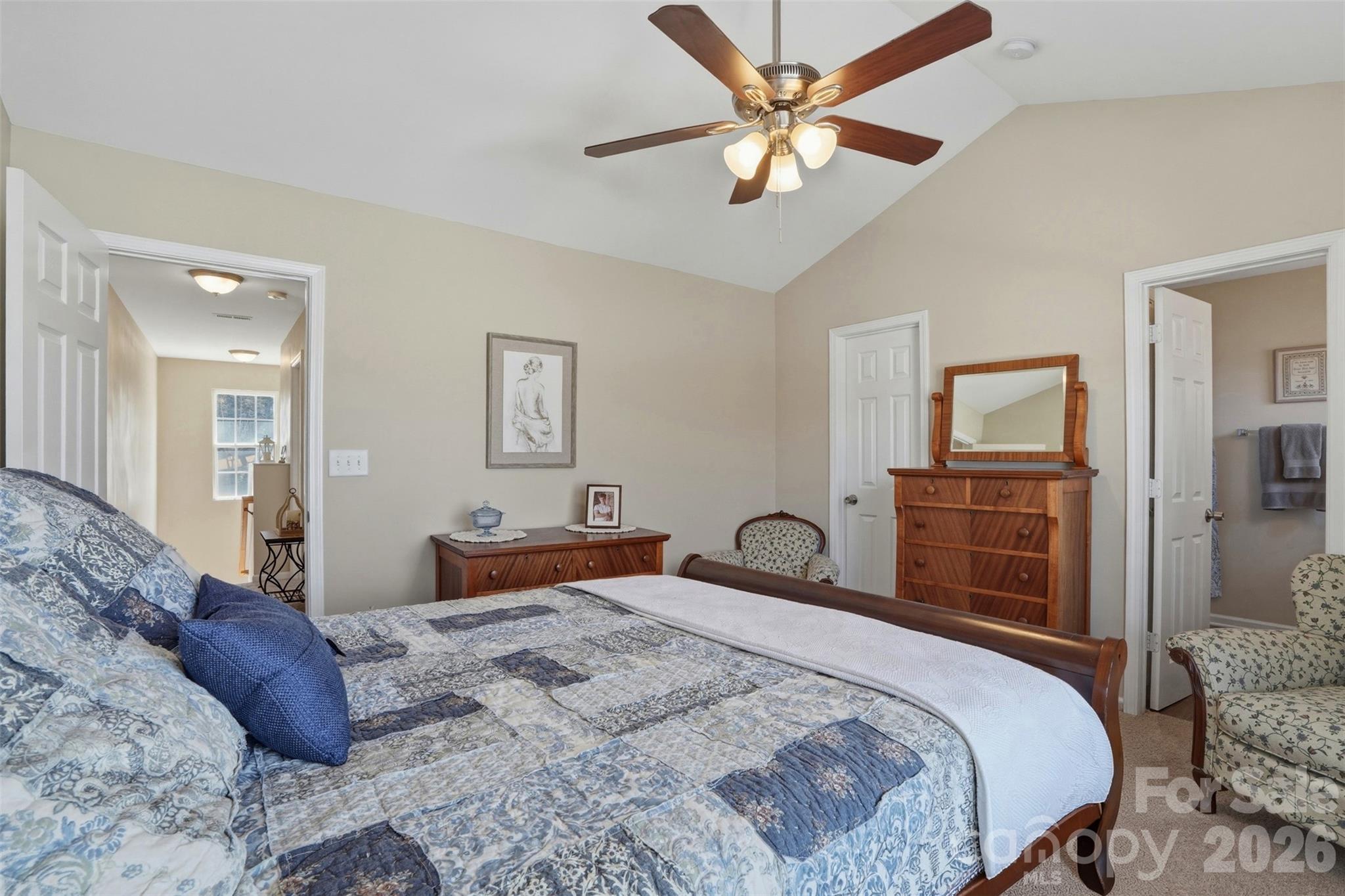 2262 Hanover Drive Fort Mill, SC 29707 - Photo 19 of 26 a bedroom with a large bed and a chandelier