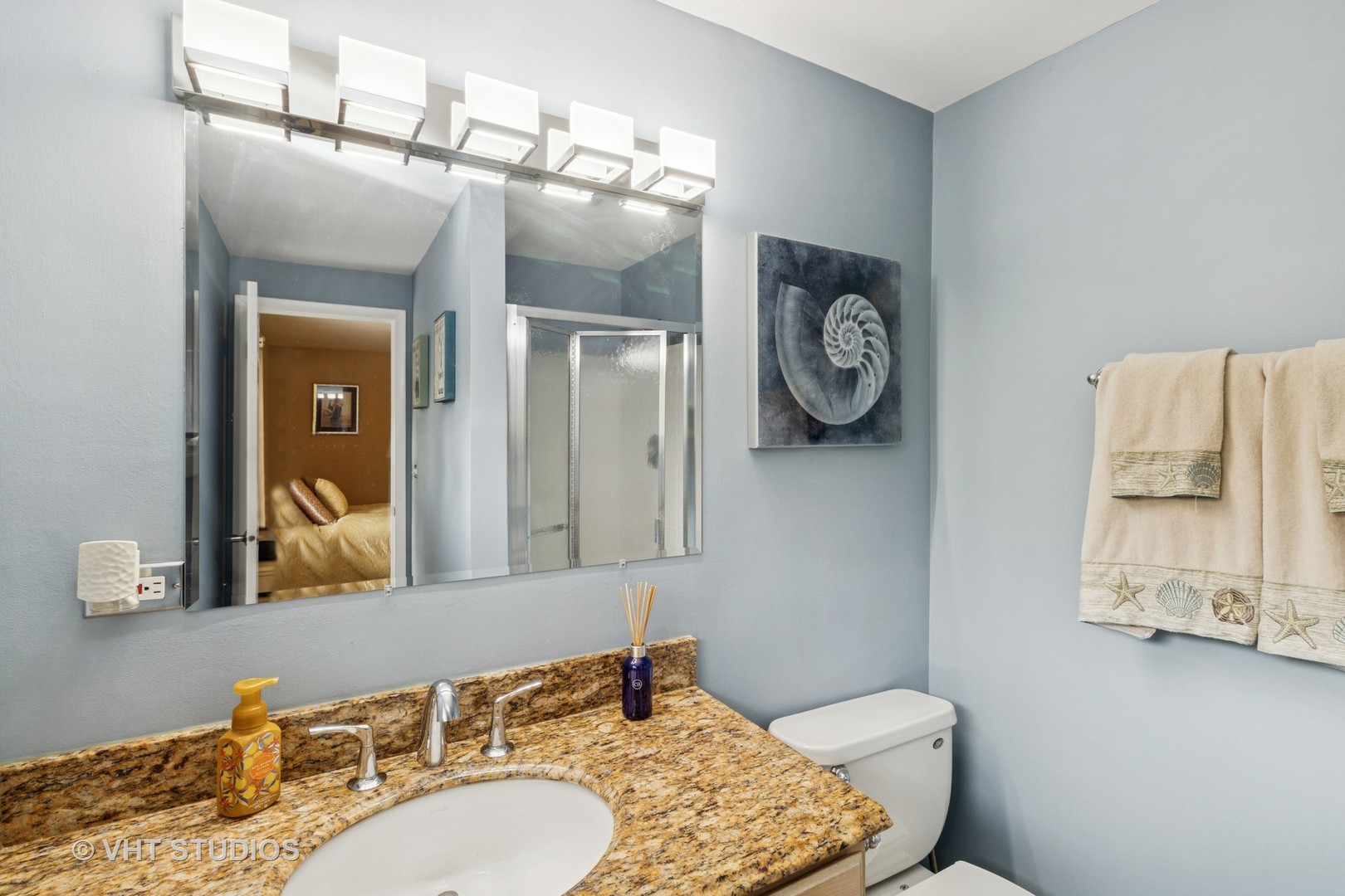 53 North Main Street Glen Ellyn, IL 60137 - Photo 12 of 30 a bathroom with a granite countertop toilet a sink and a mirror
