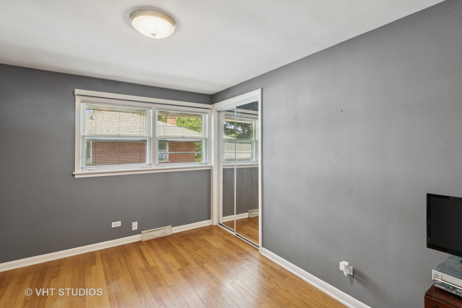 53 North Main Street Glen Ellyn, IL 60137 - Photo 16 of 30 a view of an empty room with wooden floor and a window