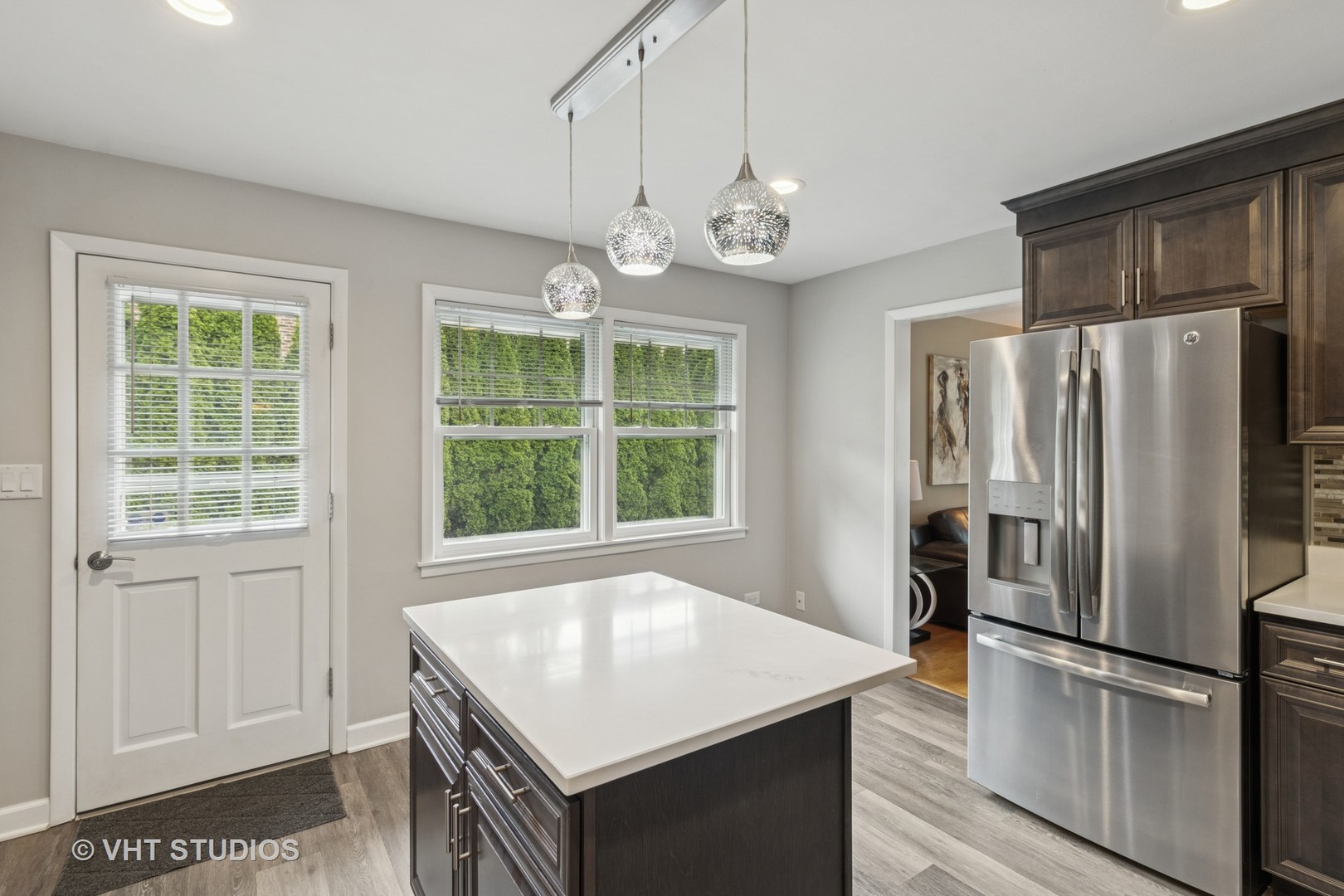 53 North Main Street Glen Ellyn, IL 60137 - Photo 4 of 30 a kitchen with a refrigerator a sink stainless steel appliances cabinets and a window