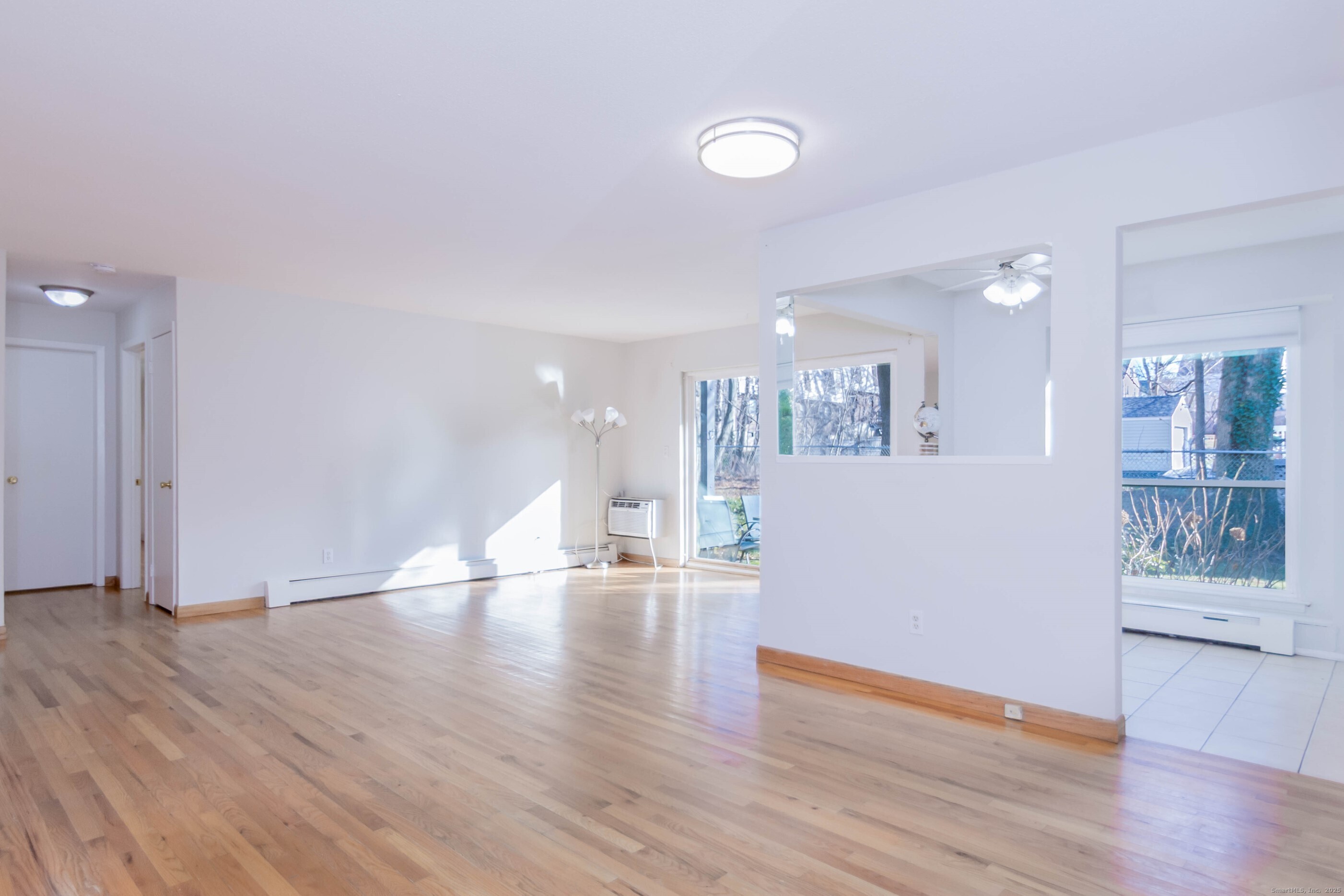 533 Glendale Avenue, Unit 533 Bridgeport, CT 06606 - Photo 4 of 15 a view of an empty room with wooden floor and a window