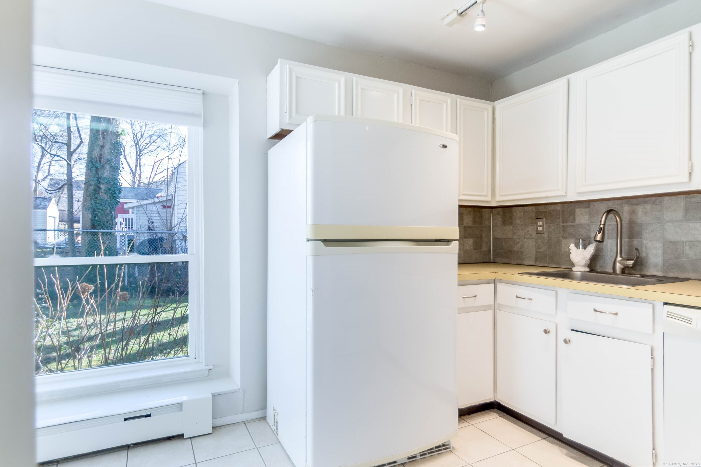 533 Glendale Avenue, Unit 533 Bridgeport, CT 06606 - Photo 6 of 15 a white refrigerator freezer sitting inside of a kitchen