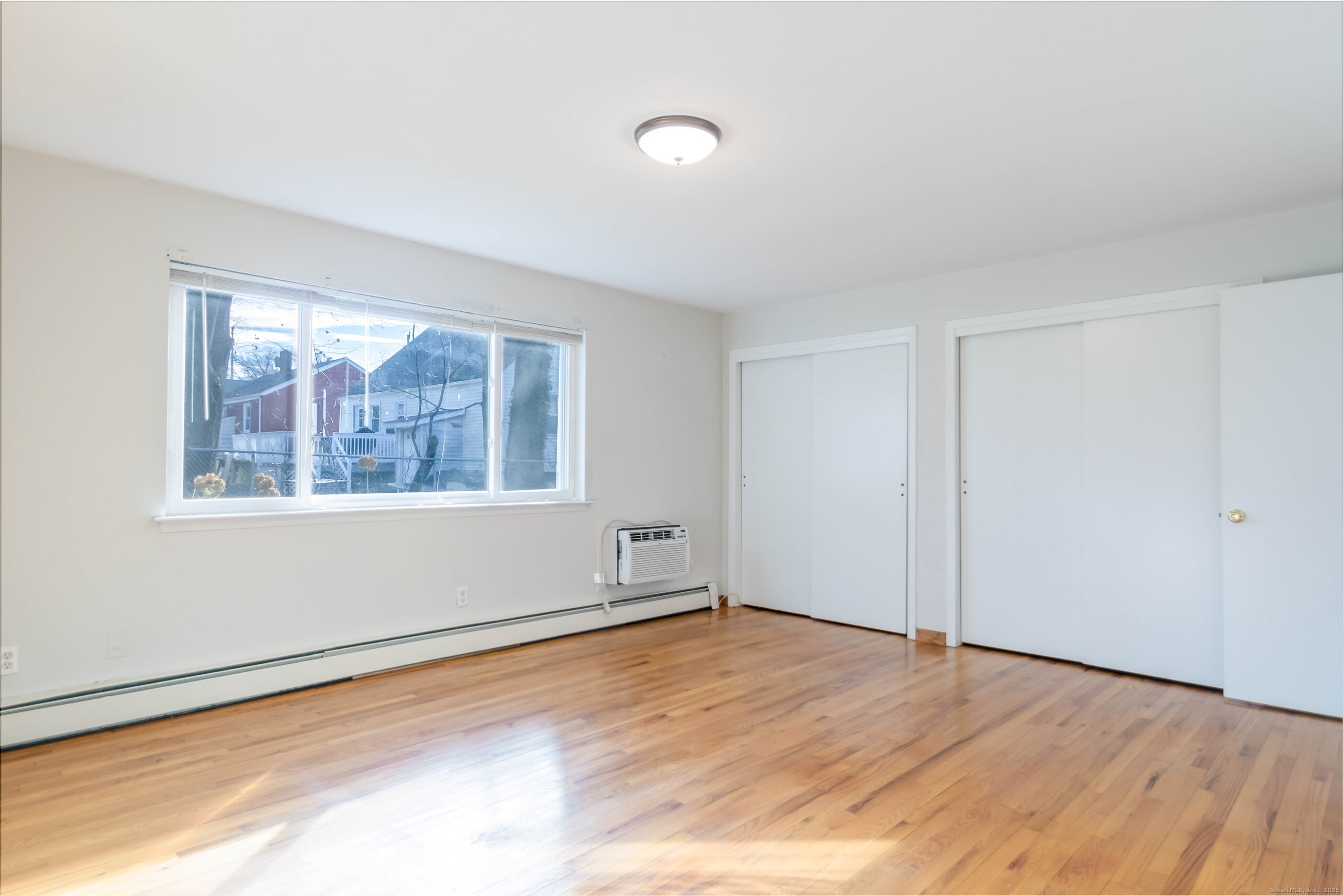 533 Glendale Avenue, Unit 533 Bridgeport, CT 06606 - Photo 9 of 15 a view of empty room with wooden floor and fan