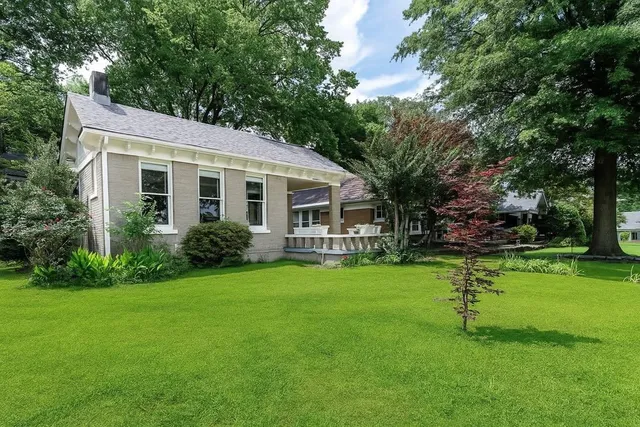 a front view of a house with a garden