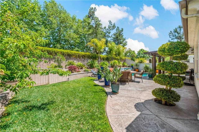 a front view of a house with a garden and sitting area