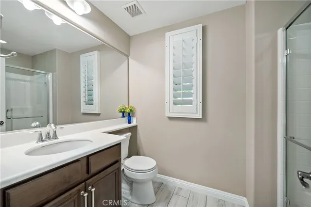 a bedroom with a large bed a flat tv screen and dresser