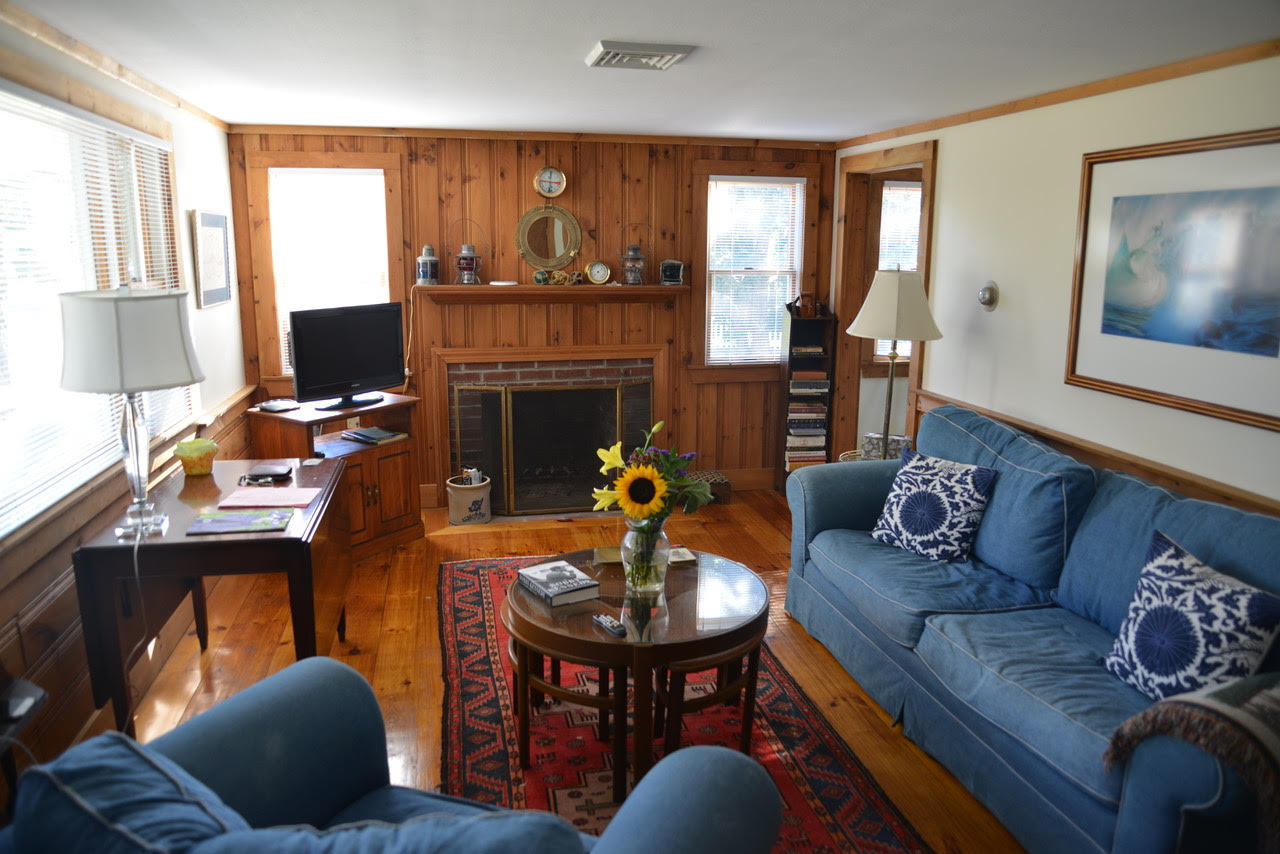 21 Santucket Road West Dennis, MA 02670 - Photo 3 of 10 a living room with furniture and a fireplace