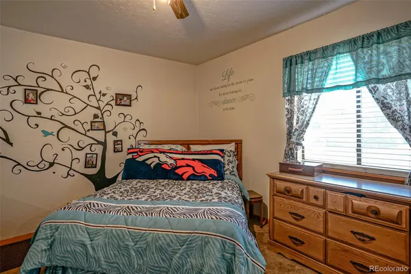 a bed sitting in a bedroom next to a window