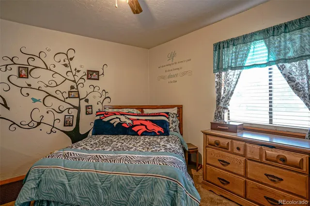 a bed sitting in a bedroom next to a window
