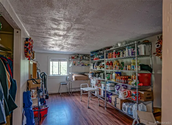 a room with lots of wooden furniture and a book shelf