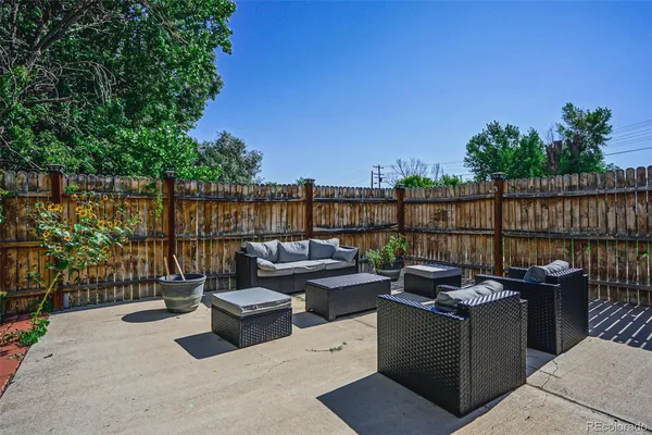 a terrace with outdoor seating and city view