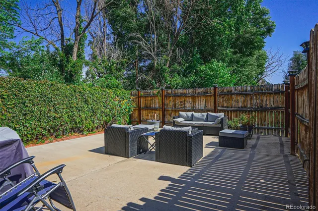 a view of a roof deck with couches and potted plants