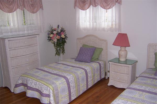 47 Bay Shore Road Barnstable, MA 02601 - Photo 14 of 22 a bedroom with a bed and a lamp on dresser