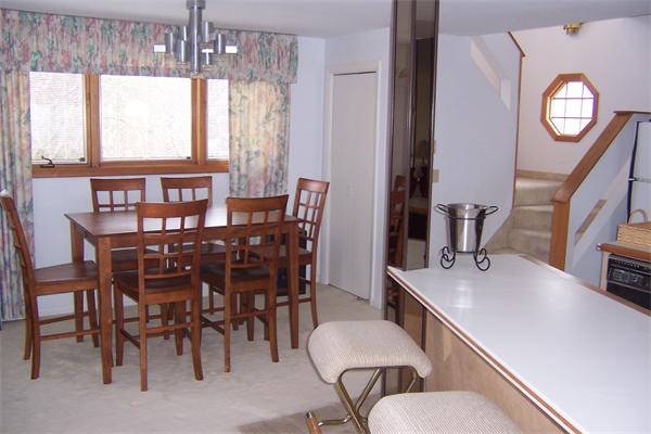 47 Bay Shore Road Barnstable, MA 02601 - Photo 4 of 22 a dining room with furniture a chandelier and window