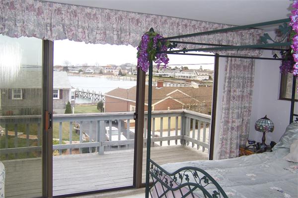 47 Bay Shore Road Barnstable, MA 02601 - Photo 6 of 22 a bedroom with furniture and a window
