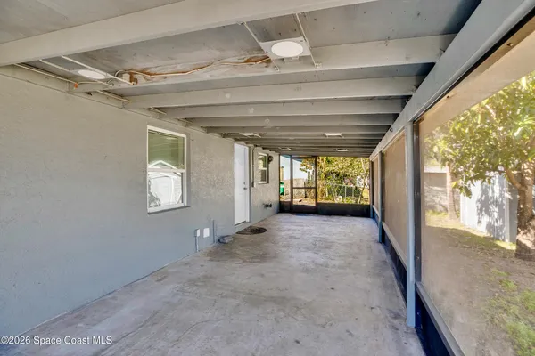 a view of a livingroom with wooden floor and a window