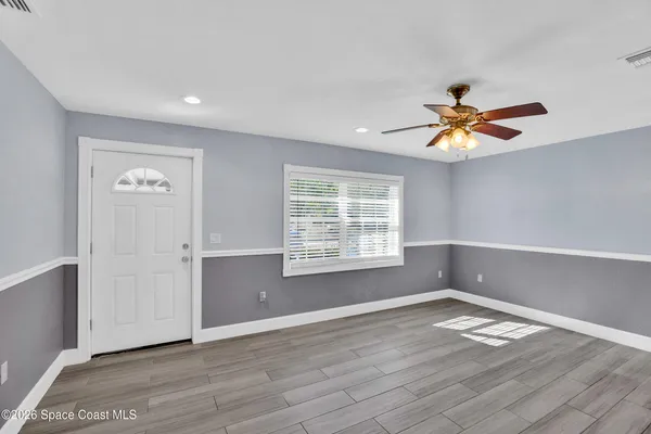 wooden floor in an empty room with a window