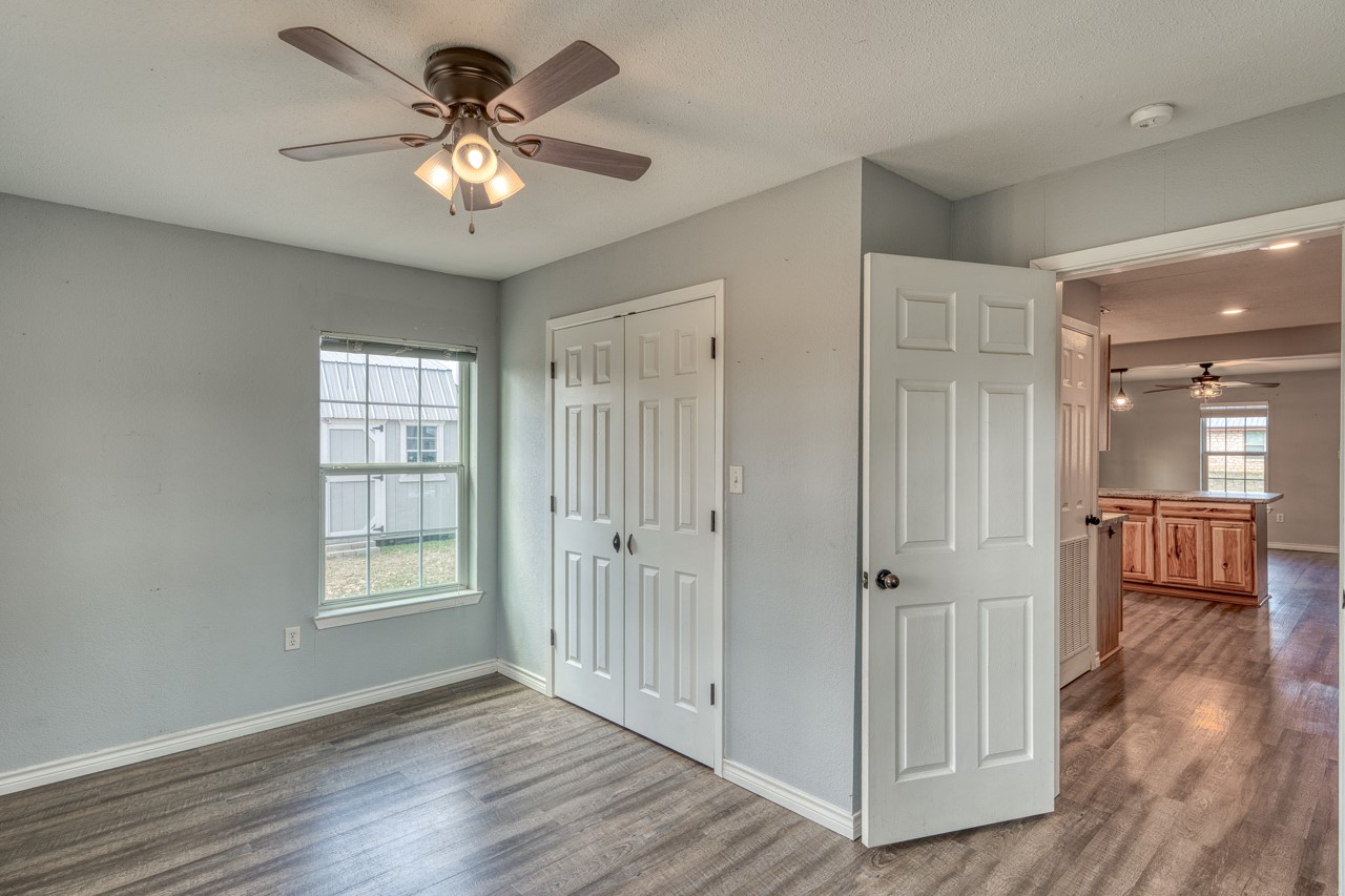 609 Dickson Street Lexington, TX 78947 - Photo 12 of 36 wooden floor in an empty room with a window