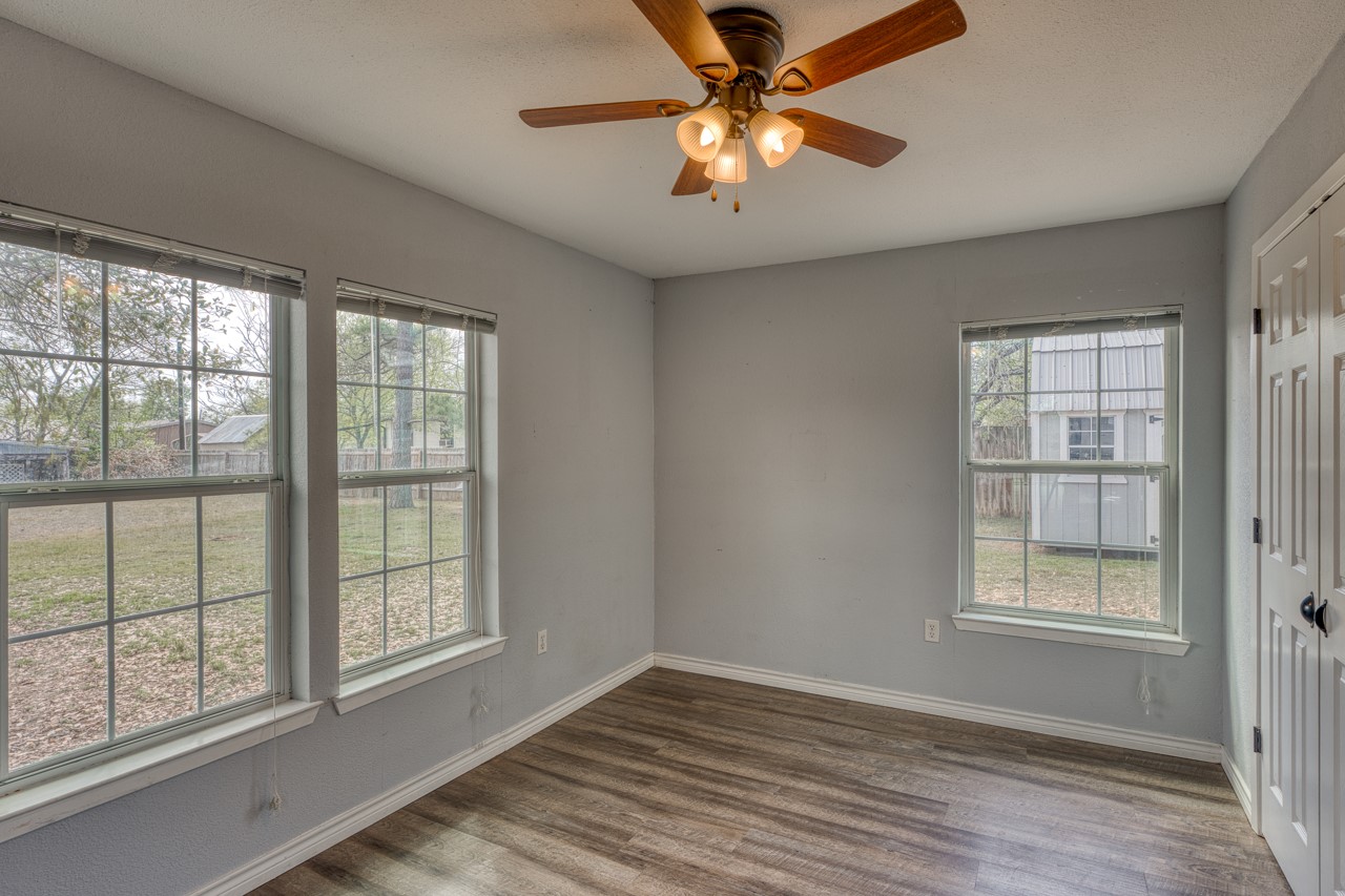 609 Dickson Street Lexington, TX 78947 - Photo 13 of 36 wooden floor in an empty room with a window