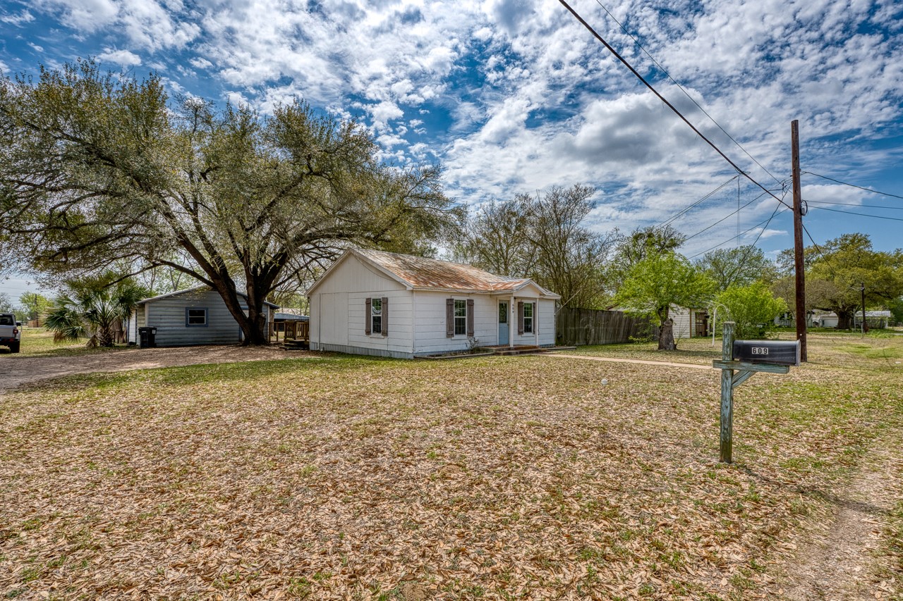 609 Dickson Street Lexington, TX 78947 - Photo 20 of 36 a house with trees in front of it