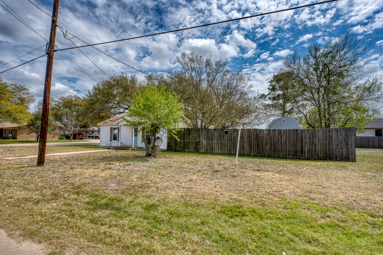 609 Dickson Street Lexington, TX 78947 - Photo 21 of 36 a house view with a play ground in front of it