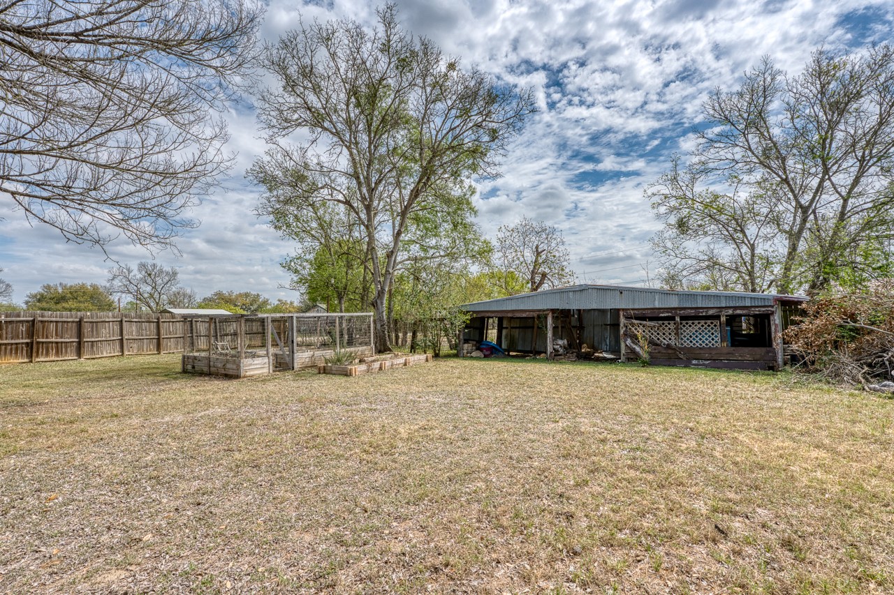 609 Dickson Street Lexington, TX 78947 - Photo 26 of 36 a view of a house with a yard and large trees