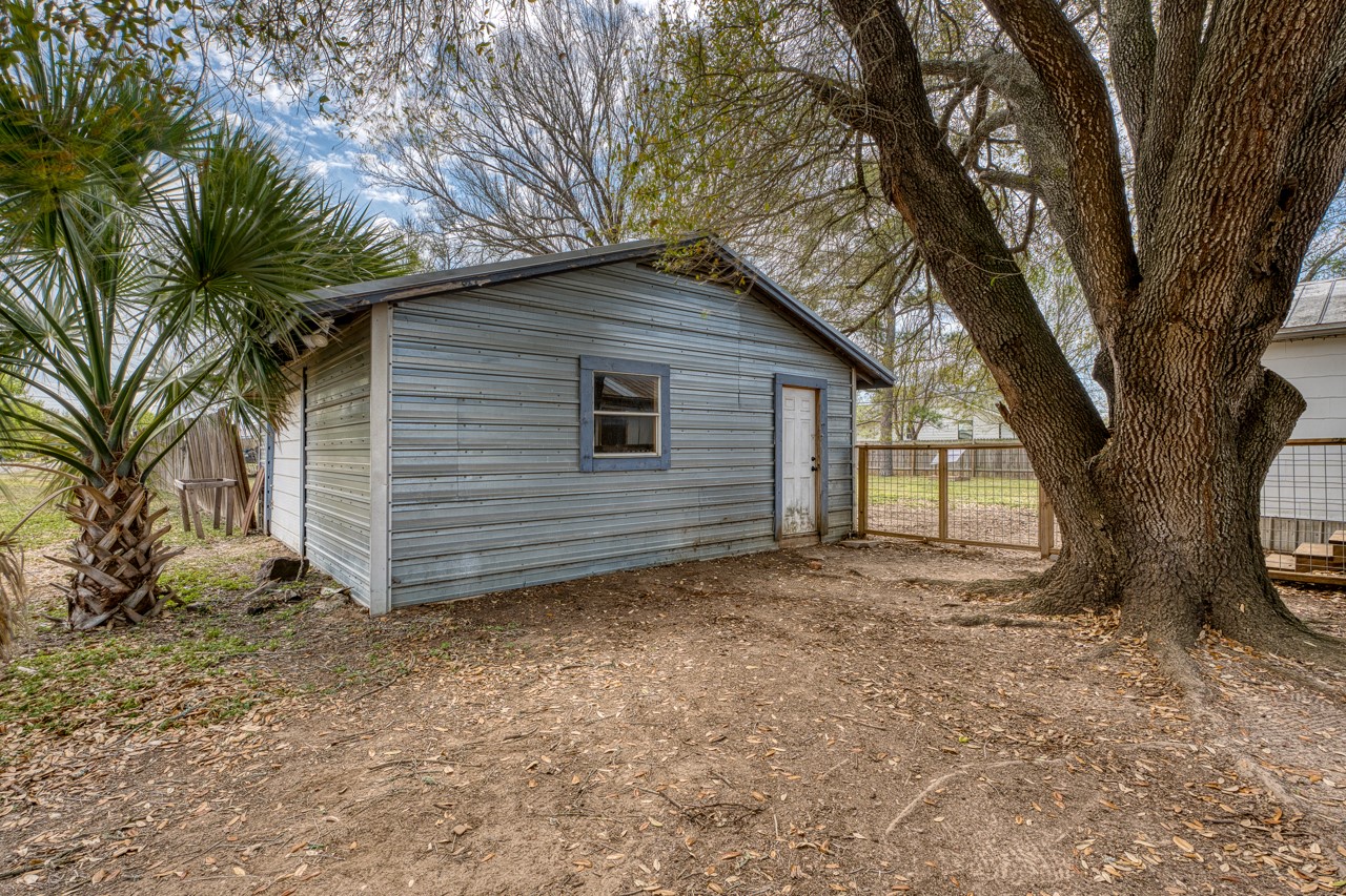 609 Dickson Street Lexington, TX 78947 - Photo 32 of 36 a view of a house with a large tree and a large tree