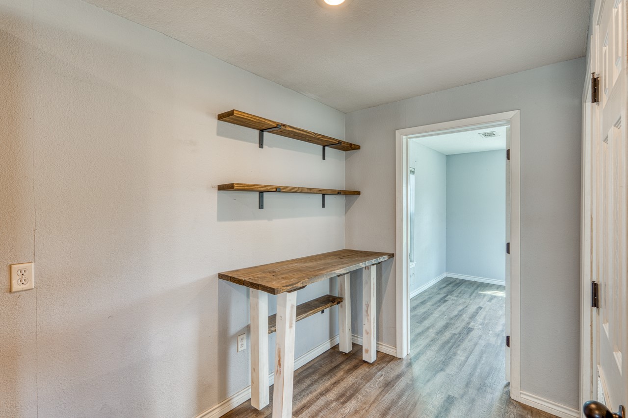 609 Dickson Street Lexington, TX 78947 - Photo 4 of 36 a view of storage and utility room in wooden floor