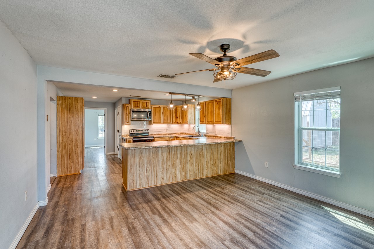 609 Dickson Street Lexington, TX 78947 - Photo 7 of 36 a view of kitchen with wooden floor and window