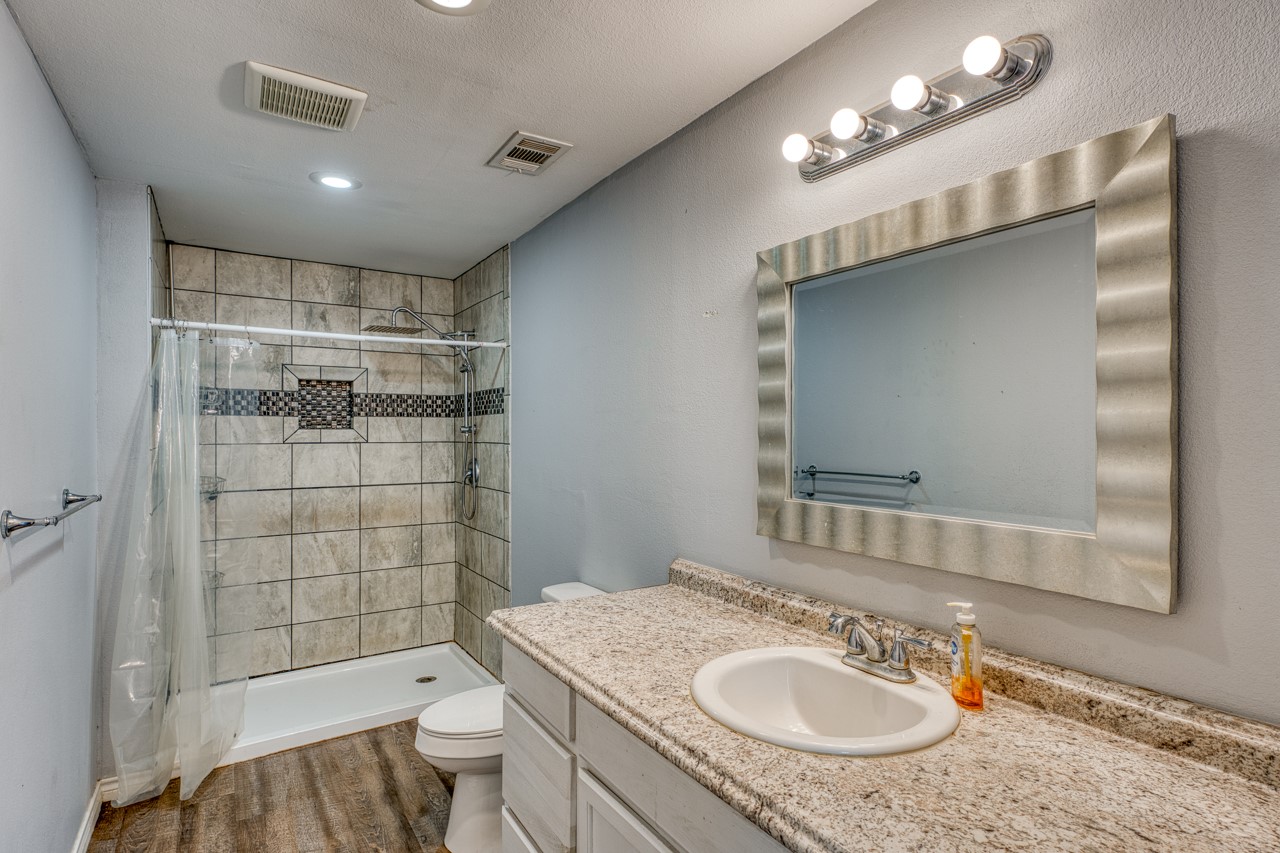 609 Dickson Street Lexington, TX 78947 - Photo 10 of 36 a bathroom with a sink a toilet and shower