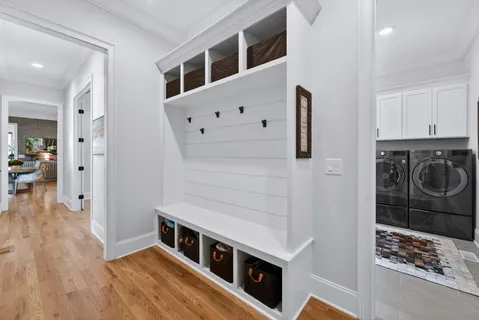 a view of entryway and hall with wooden floor