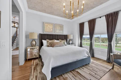 a bathroom with a toilet a sink a mirror a vanity and shower