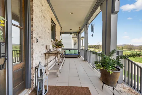 a living room with furniture a fireplace and a chandelier