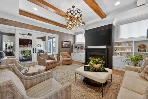 a kitchen with stainless steel appliances granite countertop a table chairs sink and stove top oven