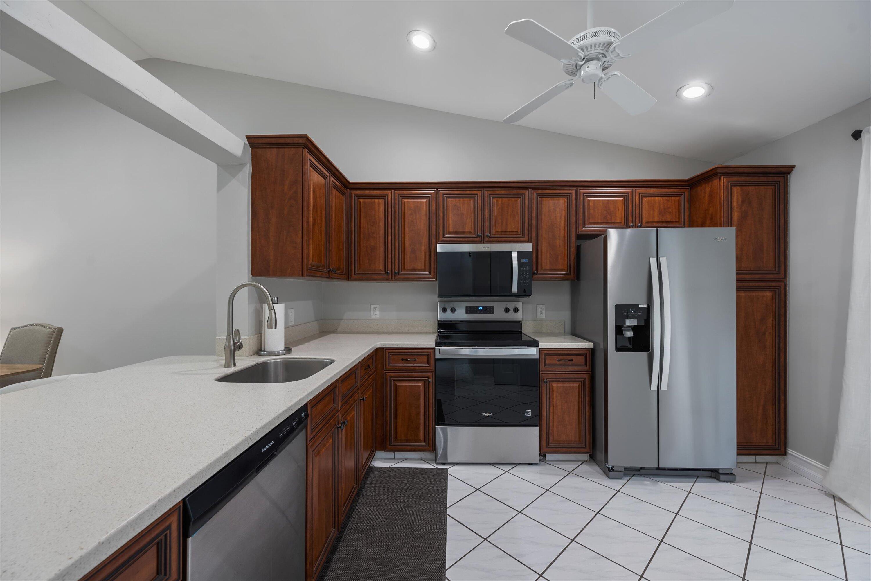 12970 Dartford Trail, Unit 4 Wellington, FL 33414 - Photo 12 of 23 a kitchen with stainless steel appliances a refrigerator sink and cabinets