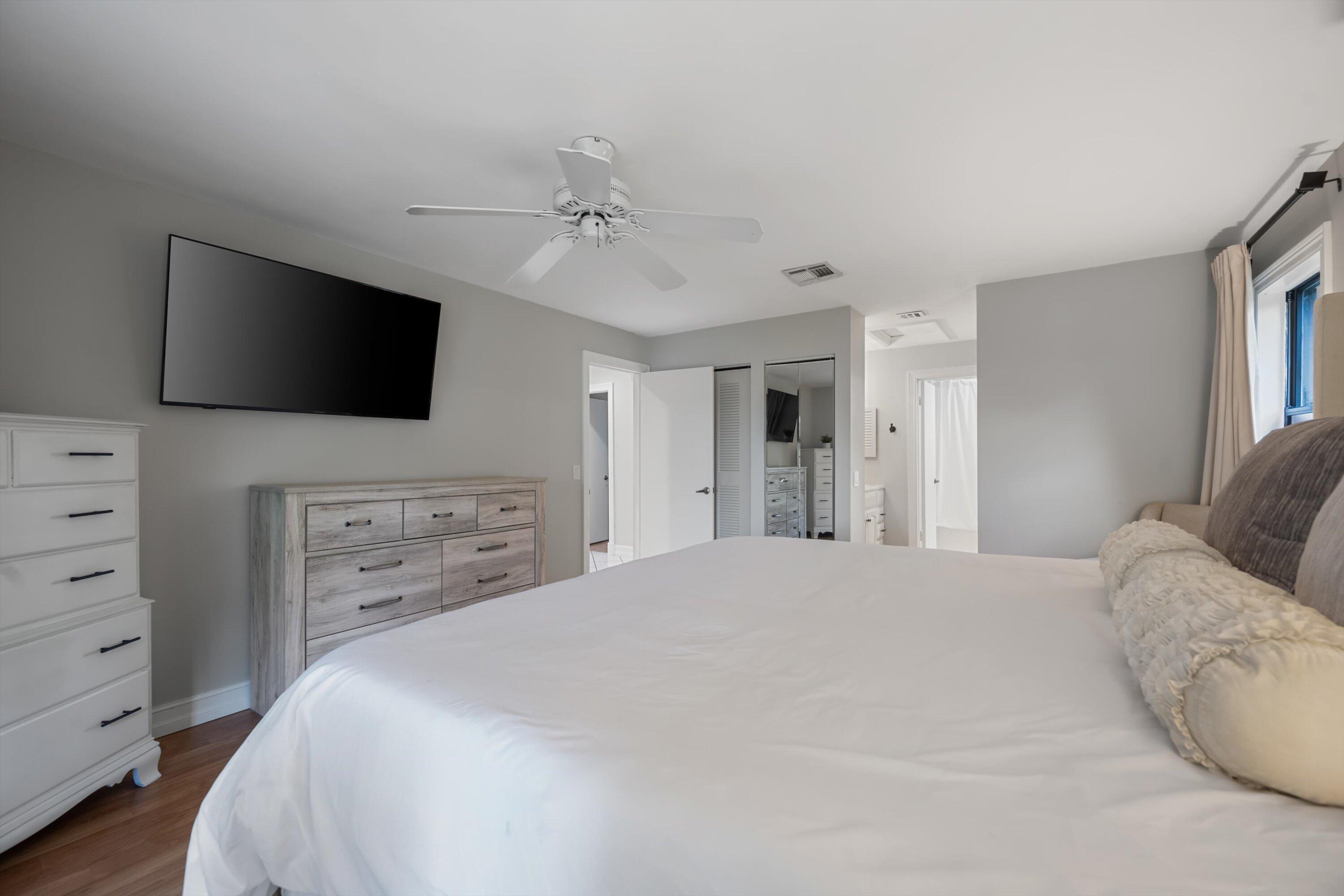 12970 Dartford Trail, Unit 4 Wellington, FL 33414 - Photo 15 of 23 a spacious bedroom with a bed and a flat screen tv